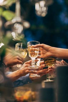 several people holding wine glasses in their hands