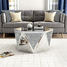 a living room with a gray couch and white rug on the floor next to a window