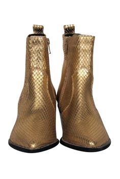 Let your inner glam rockstar out with these totally eye-catching booties from Carvela! Made with real snakeskin in a flashy gold tone, these bad boys are the perfect statement piece for your next night out. Style with leather pants and a crop top for an edgy and out-there look that’s sure to turn heads as soon as you step in the club! Size 6 (EU 36) Gold snakeskin upper Short shaft Pointed toe Stacked heel Leather sole and footbed w/ no wear Shaft 3.5” Heel 2.25” Gold Ankle Boots For Winter, Gold Western Boots For Winter, Trendy Gold Boots For Fall, Trendy Gold Leather Boots, Glamorous Gold Leather Boots, Snake Print Party Boots For Fall, Fall Party Boots With Snake Print, Snake Print Boots For Fall Party, Party Snake Print Ankle Boots