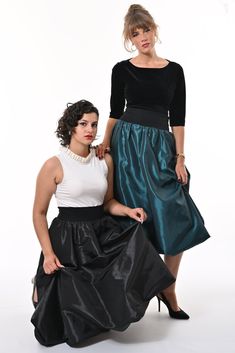 Tale: Pull on our Enoki Puffball Skirt for an evening extravaganza. The deep side pockets are a must on a night out and these can fit your phone as well as all of your other essentials. The gorgeous deep waistband cinches in your waist without being tight and this skirt is fully lined with soft jersey for ultimate comfort. The crisp teal taffeta gathers beautifully at the waist adds volume to the skirt that captures the light beautifully and makes you sure to stand out from the crowd. Our model is 5ft 9" and wears an S with our Primrose Top. Please see our size guide. 100% Polyester Taffeta, 95% Cotton 5% Elastane waistband and 95% Viscose 5% Lycra lining. Made in Britain Wash at 30* Warm Tumble Dry Warm Iron Do Not Bleach Do Not Dry Clean Evening Taffeta Skirt, Fitted Taffeta Party Skirt, Fitted Taffeta Skirt For Parties, Evening Gathered Taffeta Skirt, Evening Taffeta Gathered Skirt, Taffeta Flared Skirt For Evening, Evening Flared Taffeta Skirt, Evening Taffeta Flared Skirt, Voluminous Taffeta Skirt With Lining