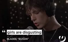 a young man wearing headphones and holding a microphone with the words girls are disgusting on it