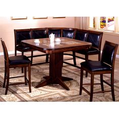 a dinning room table with four chairs around it