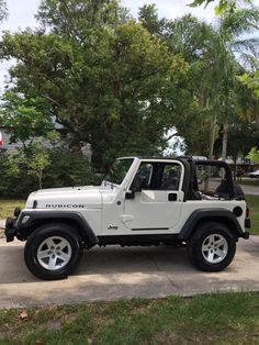 a white jeep is parked in the driveway