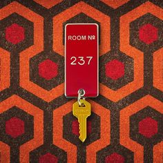 the room no 377 keychain is attached to an orange and brown carpet