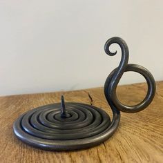 a metal sculpture sitting on top of a wooden table