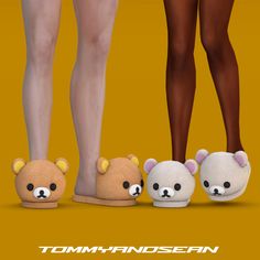 there are four stuffed animals standing in front of a woman's legs and feet