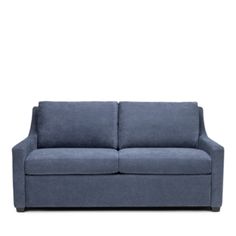 a blue couch sitting on top of a white floor