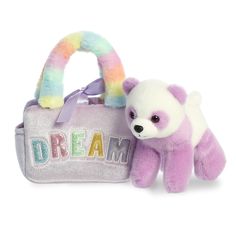 a small stuffed animal sitting next to a bag with the word dream on it's side