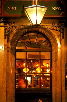 an entrance to a restaurant with the lights on