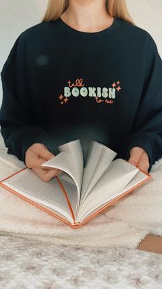 Embroidered "Talk Bookish to Me" Sweatshirt | Cozy Custom Book Lover Sweatshirt** This cozy, embroidered sweatshirt is perfect for book lovers who can't resist a good literary conversation. Featuring the playful phrase "Talk Bookish to Me" in fun bubble letters, this sweatshirt is a charming addition to any bookworm's wardrobe. **Customize Your Sweatshirt**   Choose from a variety of color combinations to make this sweatshirt uniquely yours! The thread colors will match exactly as shown in the p Cheap Bookish Cotton Shirt, Cheap Bookish Letter Print Sweatshirt, Cheap Literary Crew Neck Sweatshirt, Cheap Crew Neck Bookish Sweatshirt, Fun Bubble Letters, Adventure Gifts, Lover Sweatshirt, Book Clubs, Love Of Reading