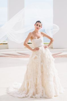 a woman in a wedding dress posing for the camera