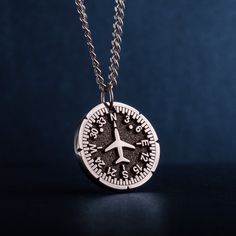 "Airplane Heading Indicator Necklace. Introducing our personalized round unisex pendant - a unique and thoughtful gift for Cabin crew, Flight attendants, adventure and travel lovers. The pendant features a captivating image of a Heading Indicator and aircraft. The Heading Indicator represents direction and guidance, reminding the wearer to follow their path and stay true to themselves. Crafted with high-quality jewelry stainless steel, this pendant is not only stylish, but also durable - suitable for pilot, aviation enthusiasts, commuters, adventures, backpackers, and anyone who loves the great travel. The personalized round pendant is a men's necklace that makes a perfect gift for dad, husband, or guy, whether for Father's Day, his birthday, or any other special occasion. A pendant with n Souvenir Round Pendant Necklace With Charms, Compass Design Pendant Jewelry Gift, Compass Design Pendant Jewelry As Gift, Charm Necklace With Round Pendant, Engraved Pendant Necklace Souvenir, Sterling Silver Compass Necklace For Travel, Engraved Round Pendant Jewelry For Souvenir, Minimalist Compass Design Jewelry As Gift, Sterling Silver Compass Design Necklace For Travel