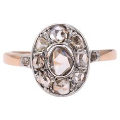 One Edwardian Diamond 14k Rose Gold Silver Cluster Ring. Featuring one rose cut diamond weighing approximately 0.20 carat, graded J color, I1 clarity. Accented by 10 rose cut diamonds with a total weight of approximately 0.90 carat, graded near-colorless, SI-I clarity. Crafted in 14 karat rose gold with a silver top. Circa 1905. The ring is a size 7 ¾ and may be resized. About this Item: Step back in time and embrace the elegance of the Edwardian era with this stunning one-of-a-kind diamond cluster ring. Featuring a mesmerizing rose cut diamond center stone and surrounded by a halo of ten additional sparkling rose cut diamonds, this ring is a true masterpiece. Crafted in 14 karat rose gold with a silver top, it exudes charm and timeless beauty. Imagine the admiration you'll receive as you Edwardian Cluster Ring, Heirloom Diamond White Diamond Ring With Rose Cut, Victorian Style Diamond White Rose Cut Diamond Ring, Oval Cluster Ring With Rose Cut Diamonds For Anniversary, Anniversary Oval Cluster Ring With Rose Cut Diamonds, Victorian Diamond Ring With Rose Cut In White Gold, Victorian White Gold Diamond Ring With Rose Cut Diamonds, Victorian White Gold Diamond Ring With Rose Cut, Victorian Oval Diamond Ring With Rose Cut Diamonds