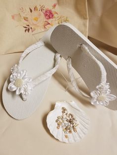 "Very simple Flat wedding sandals flipflop style 1/2\" heel. OFF-WHITE, ALSO CALLED DIAMOND WHITE. handmade flowers, the centers are a little darker than flowers; flowers are not white, flowers are Off-white. Very dressy and simple please look at the pictures. Sizes: Small: 5.5 - 6.5 Medium: 7-8 Large: 8.5 - 9.5, X-Large: 10 - 11 Please contact for any questions ON SIZING, or ANY other concerns. FINAL SALE, NO RETURNS, NO EXCHANGES, NO EXCEPTIONS." White Open Toe Wedding Shoes For Beach Wedding, White Closed Toe Sandals For Beach Wedding, White Closed Toe Flip Flops For Beach, White Round Toe Beach Wedding Shoes, Adjustable White Sandals For Beach Wedding, White Open Toe Flip Flops For Wedding, Adjustable Open Toe Flip Flops For Beach Wedding, White Flower Shaped Sandals For Beach, White Sandals For Destination Wedding In Summer