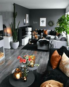 a living room filled with lots of furniture and plants on top of the coffee table