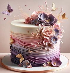 a multi - layered cake with flowers and butterflies on the top is decorated in pastel colors