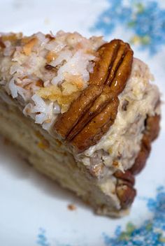 a piece of cake with pecans and coconut on top