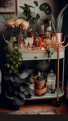 a bar cart filled with liquor bottles and plants