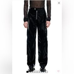 Mugler H&M. Relaxed-Fit, Biker-Style Pants In Woven Fabric With A Sheen And The Designer's Signature Twisted Seams At Front And Back. Extended Waistband Tab With Snap Fastener, Visible Zipper At Front, An Embossed Motif At Back With The Designer's Logo, And Side Pockets With Zipper. Gently Tapered Legs With Zipper At Hems. Lined. Composition Lining: Cupro 100%, Shell: Polyester 90%, Polyurethane 10% Biker Pants With Belt Loops And Straight Leg, Edgy Trousers With Zip Fly, Edgy Wide Leg Pants With Zip Fly, Black Biker Pants With Zip Fly, Black Pants With Zip Fly, Black Straight Pants With Zip Fly, Black High Waist Biker Pants, Black High-waist Biker Pants, Mugler Pants