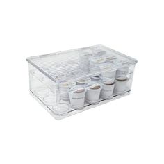 a clear plastic container filled with cups and sauces on top of a white surface