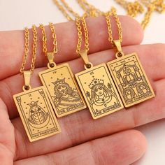 three gold pendants with the four of wands on them