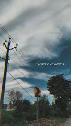 a street sign sitting next to a power pole under a cloudy sky with the words forever is an illusion