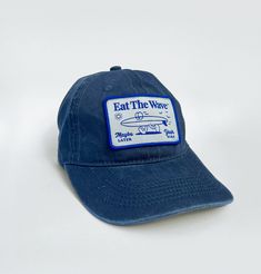 EAT THE WAVE - Yeah Sure Crafted with a classic silhouette and a faded blue hue. Hit the beach in ultimate comfort with our pre-washed cotton surf-style hat. Engineered to provide a relaxed, broken-in feel from the get-go. Vintage Surf, Surf Style, The Wave, Classic Silhouette, Blue Hues, Trucker Cap, Hat Fashion, Etsy Vintage, Baseball Cap