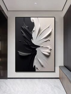 an abstract black and white painting hangs on the wall in a modern room with marble flooring