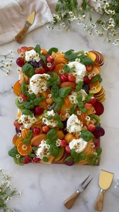 a square platter filled with fruit and cheese