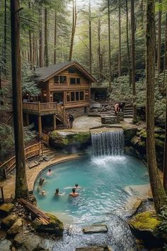 people are swimming in a pool surrounded by trees and rocks, with a cabin on the other side