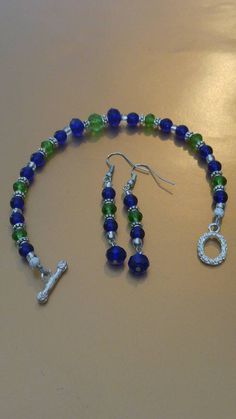 Green And Blue Beaded Bracelet, Green Glass Jewelry With Colorful Beads, Blue-green Round Beads Jewelry Gift, Seahawks Beaded Earrings, Blue-green Round Beads Jewelry For Gifts, Adjustable Blue-green Beaded Jewelry, Seahawk Earrings, Unique Green Beaded Nickel-free Earrings, Seahawks Colors