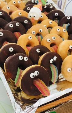 some donuts with googly eyes on them are in a box and ready to be eaten