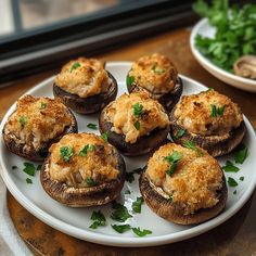 a white plate topped with mushrooms covered in cheese