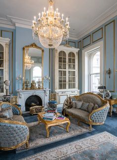 a living room filled with furniture and a chandelier