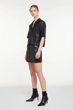 Women's Half Sleeve Short Leather Shirt In Black Embrace edgy elegance with our women's half-sleeved short leather shirt. Made from premium semi-aniline sheepskin leather, this cropped shirt features chic half sleeves and a classic turn-down collar. The button closure adds a timeless touch, while a single breast pocket enhances functionality. This top is a bold statement piece for any fashion-forward wardrobe. Outer Shell: Genuine Leather Leather Type: Sheepskin Leather Finish: Semi-aniline Feature: Cropped Leather Shirt Closure Style: Buttons Collar Style: Turn Down Sleeves: Half Outside Pockets: One Breast Pocket Color: Black Leather Short Sleeve Tops For Fall, Black Leather Collared Top, Black Short Sleeve Leather Top, Black Leather Short Sleeve Top, Chic Collared Leather Top, Casual Leather Top For Night Out, Casual Leather Tops For Night Out, Women's Half Sleeve, Leather Shorts Women