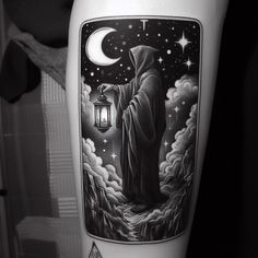 a man with a lantern in his hand on the thigh is standing under a full moon and stars tattoo