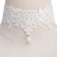 A simply lovely soft lace choker necklace featuring a dainty pearl dangle bead at the center. This choker gives a soft and romantic feel to your outfit and is really very pretty. Features an adjustable clasp closure. White Pearl Charm Choker For Party, Elegant Adjustable Cream Choker, Adjustable Elegant Cream Choker, Elegant Cream Adjustable Choker, Adjustable Pearl Charm Choker For Party, Elegant Lace Choker As Gift, Vintage Adjustable Pearl Choker, Elegant Adjustable Lace Choker, Dainty Adjustable Wedding Choker