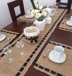 the table is set with place mats, dishes and cups for dinner guests to enjoy