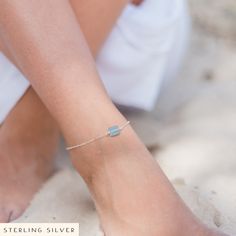 Our raw blue aquamarine crystal nugget anklet has been carefully handcrafted and can come in either bronze, stainless steel, sterling silver or 14k gold fill.  It features a raw, genuine aquamarine crystal that has been securely wire-wrapped to the chain. The anklet is approximately 8 inches wide and is adjustable with a 2-inch long extension chain. About Aquamarine:  * It is the stone of eternal youth and happiness.  * It is connected with the exhilaration and relaxation of the sea.  * It protects those travelling by, near or over water.  * It is cleansing, soothing and calming and represents truth, trust and letting go.  * It is the traditional birthstone for March, the natural birthstone for those born between 19th February and 19th March, and is the Zodiac Stone of Scorpio (23rd Octobe Adjustable Aquamarine Silver Bracelet, Adjustable Silver Aquamarine Bracelet, Adjustable Silver Aquamarine Bracelets, Adjustable Gold Sterling Silver Anklets, Delicate Adjustable Silver Anklets, Adjustable Aquamarine Jewelry As Gift, Dainty Adjustable Nickel-free Anklets, Dainty Adjustable Sterling Silver Anklets, Minimalist Hypoallergenic Sterling Silver Anklets