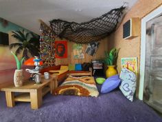 a living room filled with furniture and lots of clutter on top of purple carpet