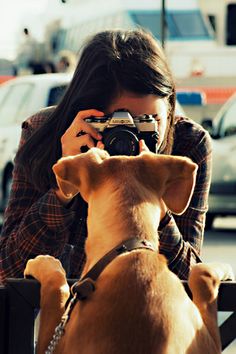 a woman taking a photo with her dog in front of some parked cars and the words, no one ever takes a photograph of something they want to do