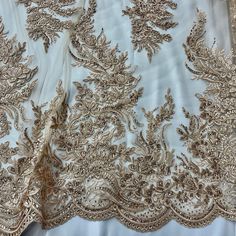 This elegant Beaded and Corded Bridal Lace Fabric from Lace USA is the perfect touch for any special occasion. Made from 100% polyester net mesh, this luxurious fabric is embroidered with stunning beads and cords and is sure to be a show-stopper at any dance, wedding, or costume event. Whether you're shopping for couture fabric or searching for the perfect fabric for a dancewear masterpiece, this bridal lace fabric is perfect for adding a regal touch to any garment. Shop with confidence and let Elegant Embroidered Fitted Lace, Elegant Lace Fabric With Resham Embroidery, Elegant Fitted Embroidered Fabric For Ceremony, Elegant Fitted Embroidered Lace, Elegant Embroidered Fabric For Mother Of The Bride, Elegant Festive Lace With Floral Embroidery, Elegant Floral Embroidered Lace For Festive Occasions, Festive Elegant Lace With Floral Embroidery, Elegant Embellished Embroidered Fabric For Mother Of The Bride