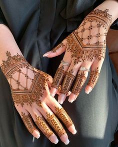 two hands with henna designs on them