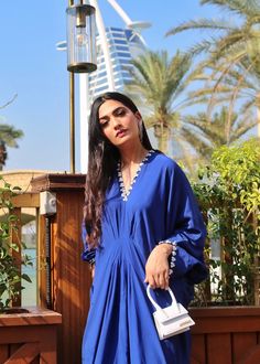 Azure blue georgette silk kaftan with details on the neckline, sleeves and back. Blue Silk Kurta For Summer, Summer Blue Georgette Kurta, Blue Georgette Kurta For Summer, Summer Blue Kurta With Embroidered Neckline, Elegant Silk Tunic For Eid, Blue Summer Kurta With Embroidered Neckline, Elegant Blue Blouse For Eid, Summer Long Sleeve Georgette Kaftan, Elegant V-neck Kaftan With Embroidered Neckline