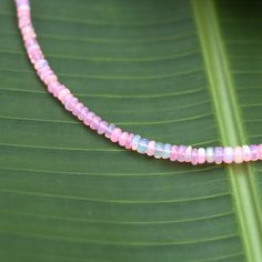 Shimmer, shine, and stand out with this gorgeous pink opal gemstone necklace. Whether you're dressing up for a special occasion or adding a touch of glamour to your everyday look, this necklace is sure to turn heads and spark conversations. Details Necklace measures 17" with extender chain Gold filled chain Genuine pink opal beads Single Strand Pink Opal Necklace With Round Beads, Dainty Adjustable Opal Necklace, Dainty Opal Adjustable Necklace, Pink Opal Jewelry With Gemstone Detail, Pink Opal Jewelry With Gemstone, Pink Jewelry With Adjustable Round Beads Chain, Pink Opal Beaded Necklace For Gift, Pink Opal Single Strand Beaded Necklace As Gift, Pink Opal Beaded Jewelry