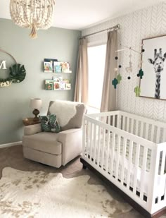 a baby's room with a white crib, chair and pictures on the wall