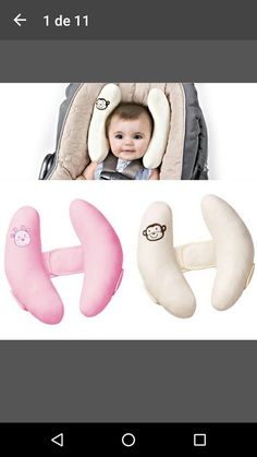 a baby sitting in a car seat with two pillows attached to it's sides