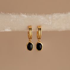 Sleek and classy, our Black Gemstone Drop Hoop Earrings are the ones you’ll never want to take off. Pair with any outfit from casual to extravagant and instantly elevate your look, yet still remaining wearable for everyday. Material: High Quality Solid 925 Sterling Silver Finish: Sterling Silver ∙ 18K Gold Featuring a ~13mm Long Dangling Earrings with a ~9.5x8mm Black Charm Sold as a Pair Part of our Mood: Brazen Black Collection Model showcases a vintage, classy look featuring our Waverly Black Black Drop Earrings, Fingerprint Necklace, Sideways Initial Necklace, Black Hoops Earrings, Dangle Earrings Wedding, Drop Hoop Earrings, Thoughtful Gifts For Her, Casual Earrings, Hoop Charms