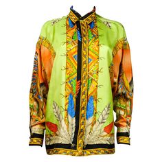 Circa 2004/2011 Italy - France Rare Couture shirt in silk twill printed with baroque and eccentric Indians by Donatella Versace from the years 2004/2011. Loose and fluid cut printed with the Atelier Versace logo which has been associated since 2004 with the red carpet and Haute Couture. Small collar with lapel and long sleeves. Printing on silk with strong polychromy representing an Indian with feathers from behind on horseback facing a sunset. Variation of the theme excessively on the sleeves a Designer Silk Printed Shirt, Designer Multicolor Silk Shirt, Luxury Silk Printed Blouse, Luxury Printed Silk Tops, Silk Long-sleeve Tops With Graphic Print, Silk Long Sleeve Tops With Graphic Print, Silk Tops With Graphic Print And Long Sleeves, Luxury Silk Top With Graphic Print, Luxury Multicolor Silk Tops