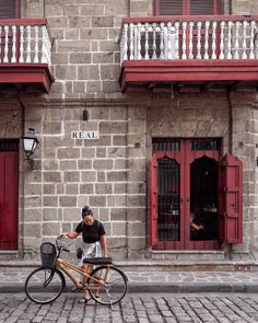 a person on a bike parked in front of a building